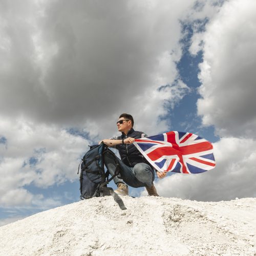 male-traveler-with-backpack-flag